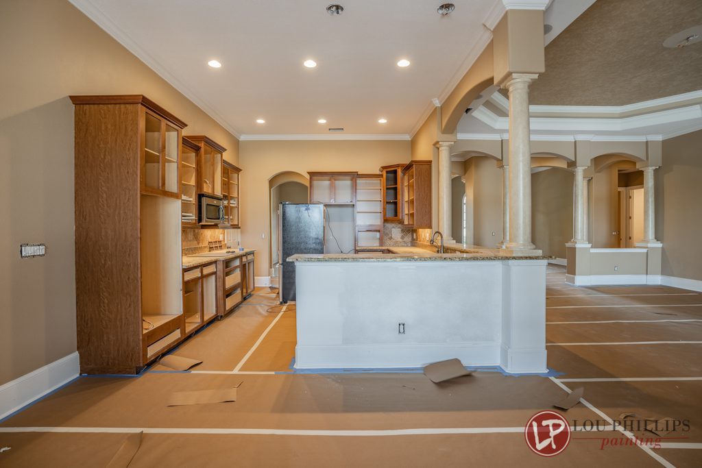 A spacious kitchen featuring a large island and modern cabinets, designed for functionality and style.