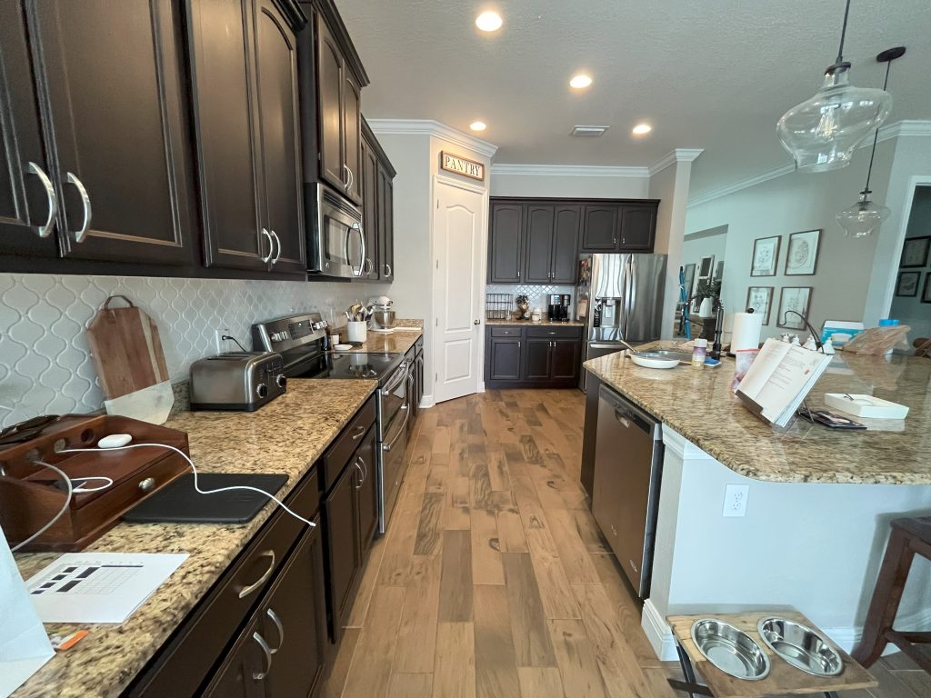 A modern kitchen featuring dark wood cabinets and elegant granite countertops.